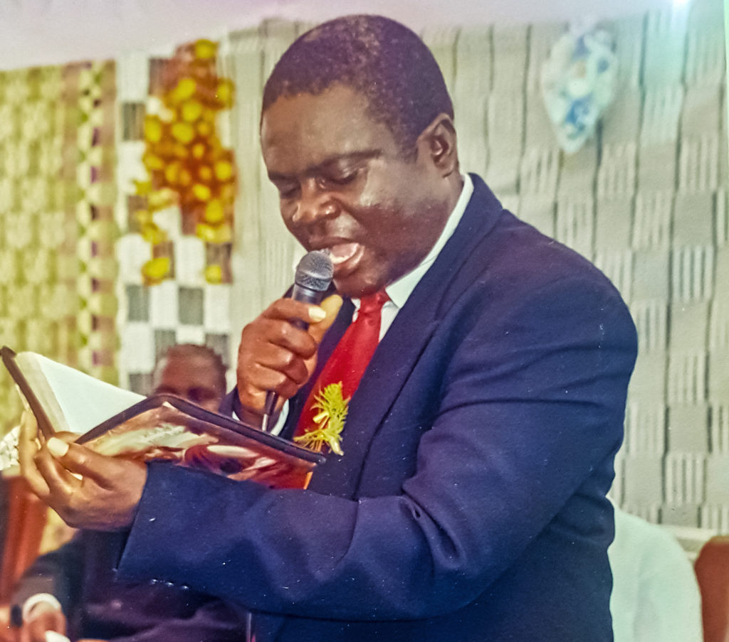 Michael Baasi preaches at his church in Ghana