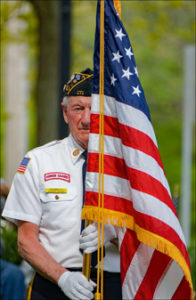 U.S. military veteran holding an American flag